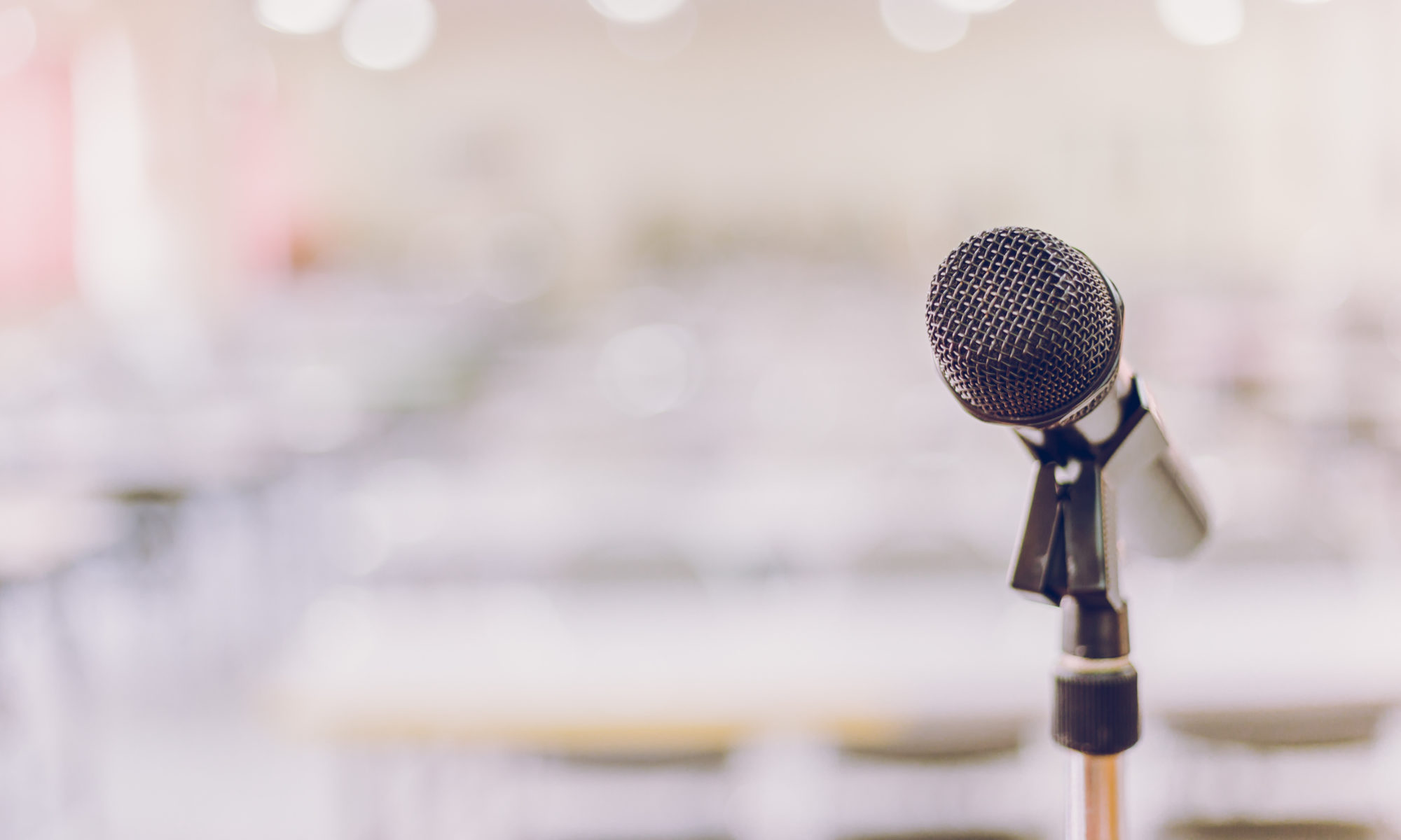 Microphone in focus at front of room