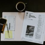 Tax worksheets, calculator, pen, coffee