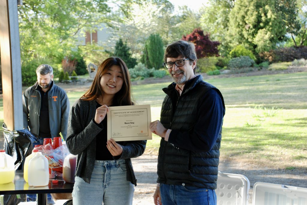 Nawon Kang being presented the Outstanding Graduate Student Award by Chris Clark, Department Head