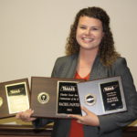 Rachel Painter, AREC alumna, holding her three 2022 TAAA&S awards