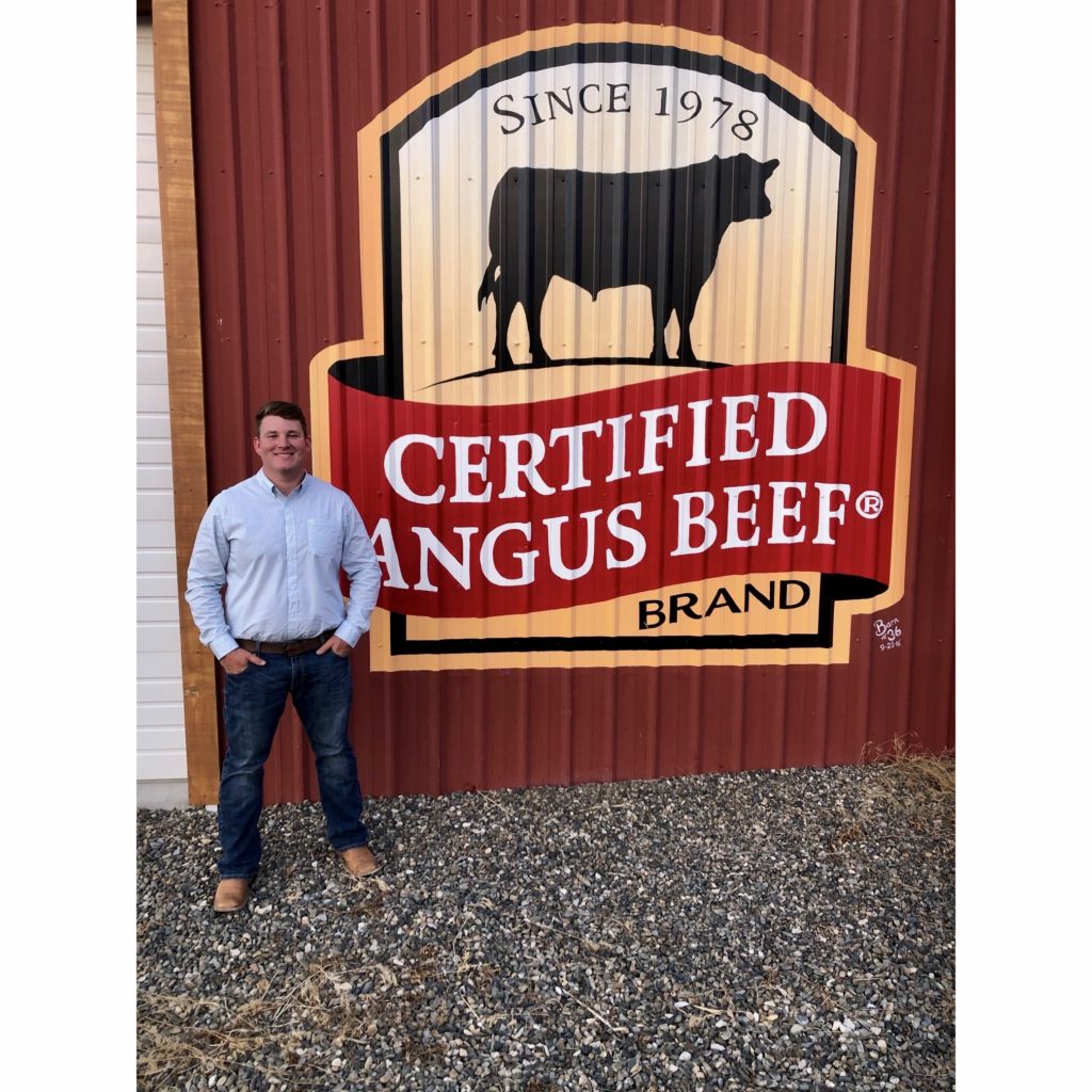 Ian Kane standing next to Certified Angus Beef sign