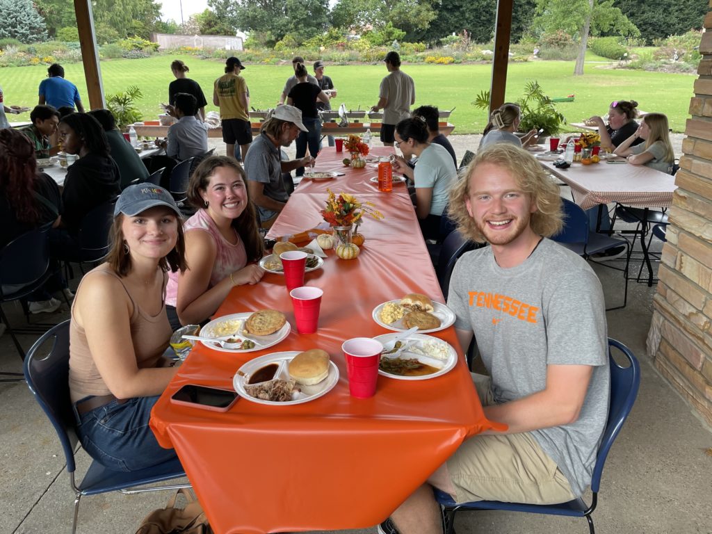 Faculty and students enjoying food and fellowship at the department's Fall picnic