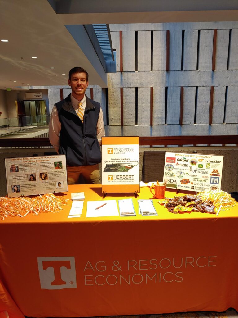 Graduate student at department's recruiting table at Southern Agricultural Economics Association annual meeting in Atlanta, Georgia