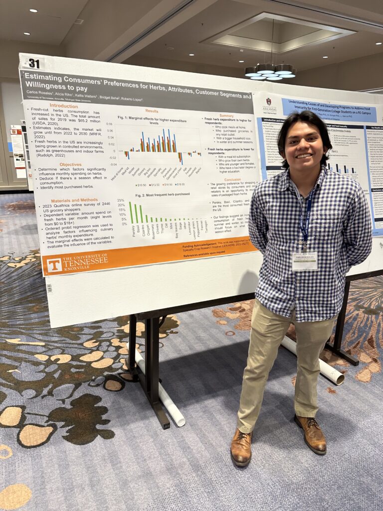 Graduate student presenting poster at Southern Agricultural Economics Association annual meeting in Atlanta, Georgia