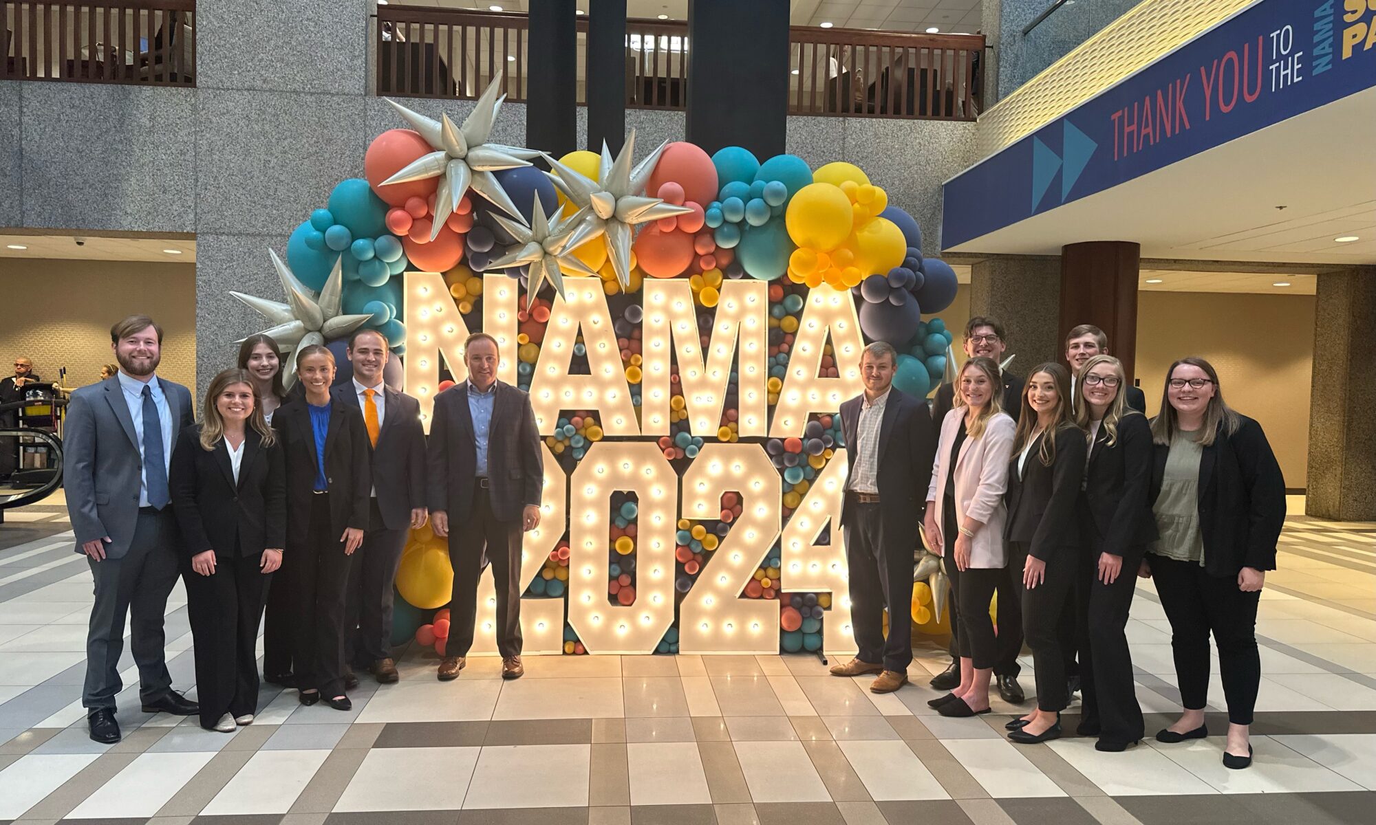 Herbert College of Agriculture's National Agri-Marketing Association Student Competition Team standing at the NAMA 2024 sign