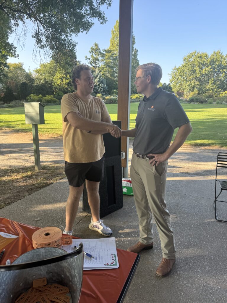 Department Head, Chris Boyer, talking to a student at the Fall 2024 picnic