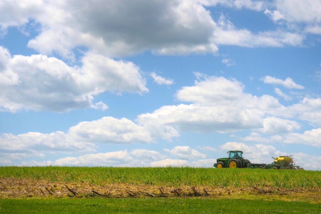 Tractor pulling a planter in a field